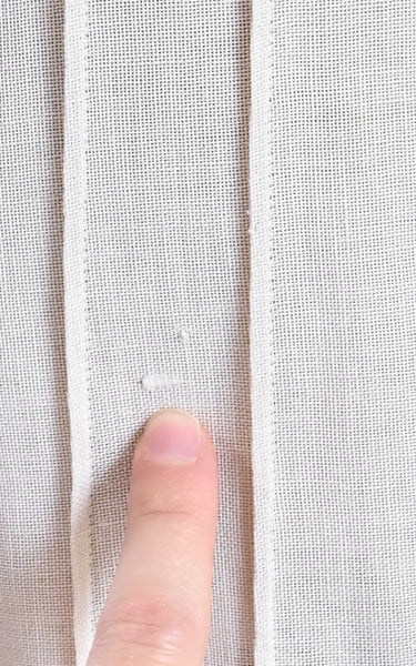 Close-up of a finger touching a textured fabric surface