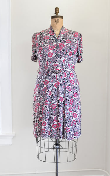 Floral dress on a mannequin against a white wall