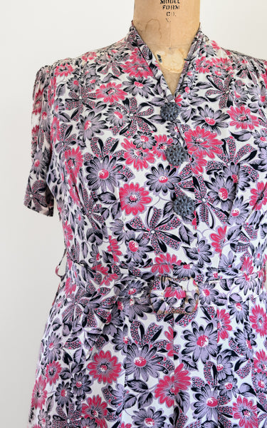 Floral patterned dress on a mannequin against a white background