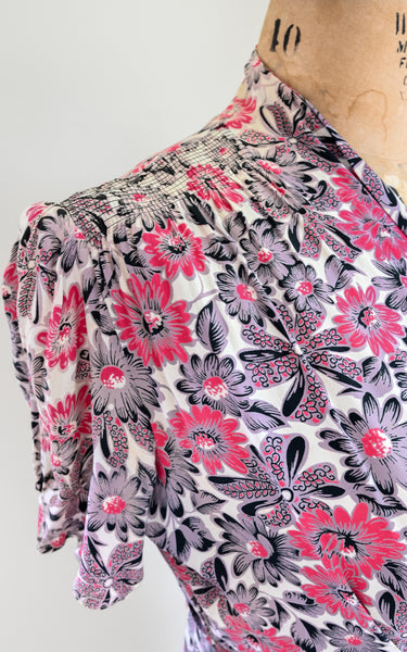 Floral patterned dress on a mannequin with a white background