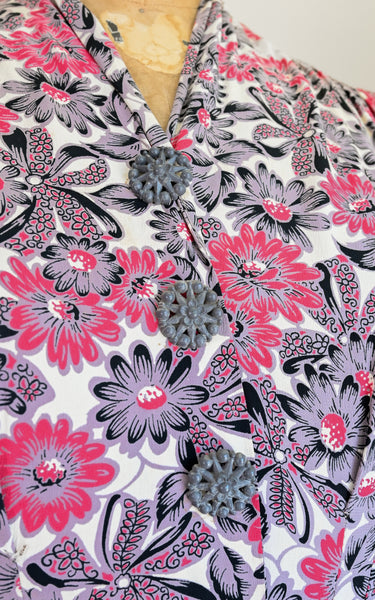 Floral patterned dress with pink and purple flowers on a white background