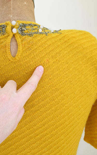 visible mends on a vintage knit top