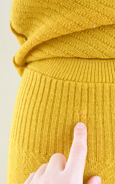 visible mends on a vintage knit skirt