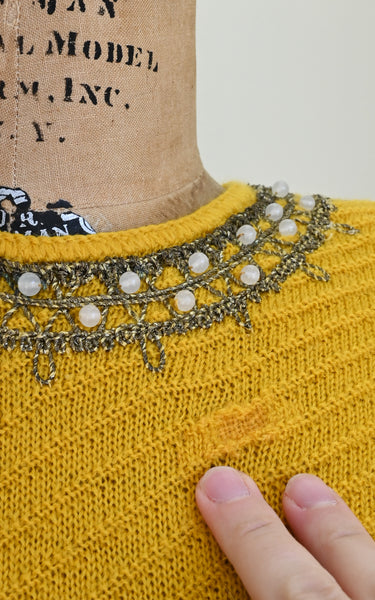 Mends visible on a vintage knit top