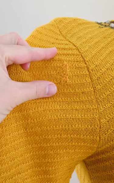 visible mends on a vintage knit top
